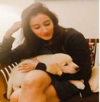 Namita has adopted a cute dog in her home. She named the dog Juno.